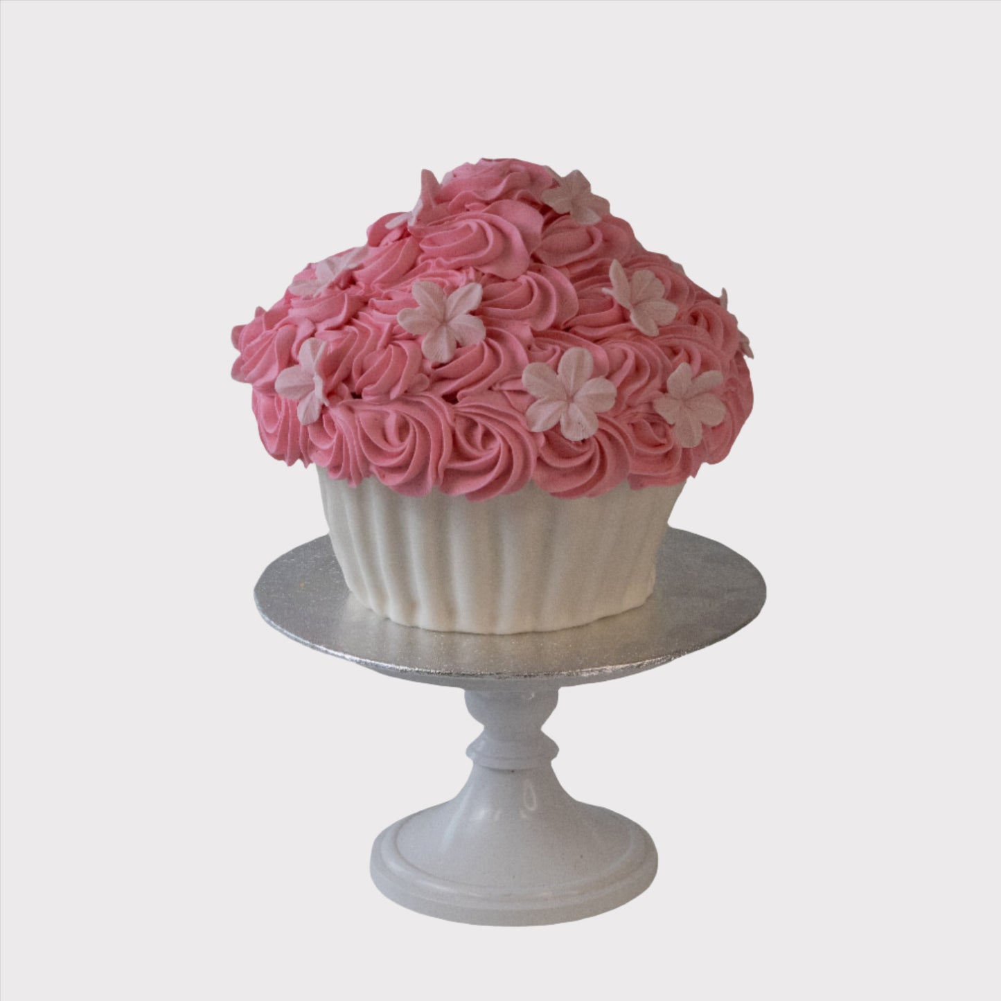 roze smashcake voor eerste verjaardag met handgemaakte botercrème
